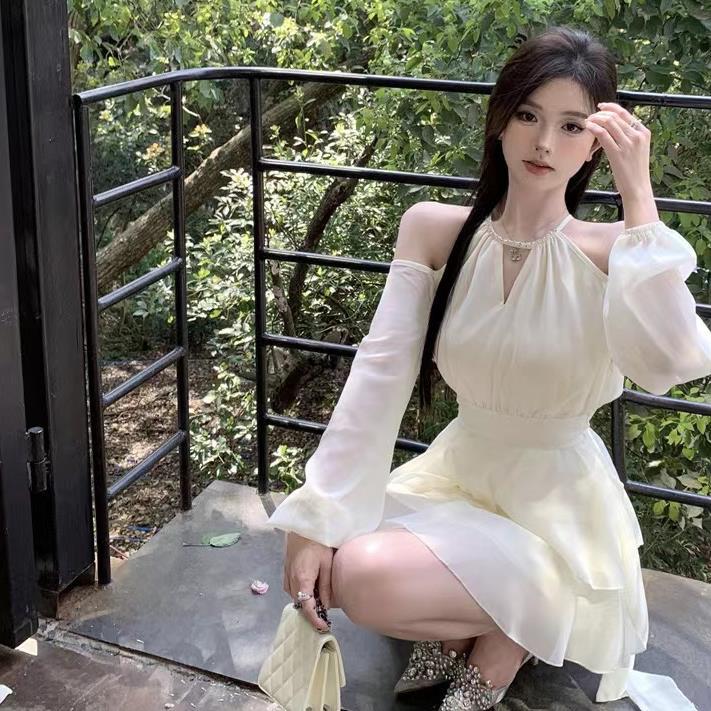 Apricotcolored Longsleeved Dress With A Cinched Waist Slimming Effect And Ethereal Ruffled Hem