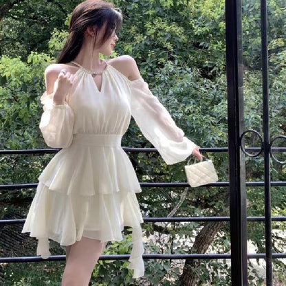 Apricotcolored Longsleeved Dress With A Cinched Waist Slimming Effect And Ethereal Ruffled Hem