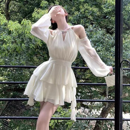 Apricotcolored Longsleeved Dress With A Cinched Waist Slimming Effect And Ethereal Ruffled Hem