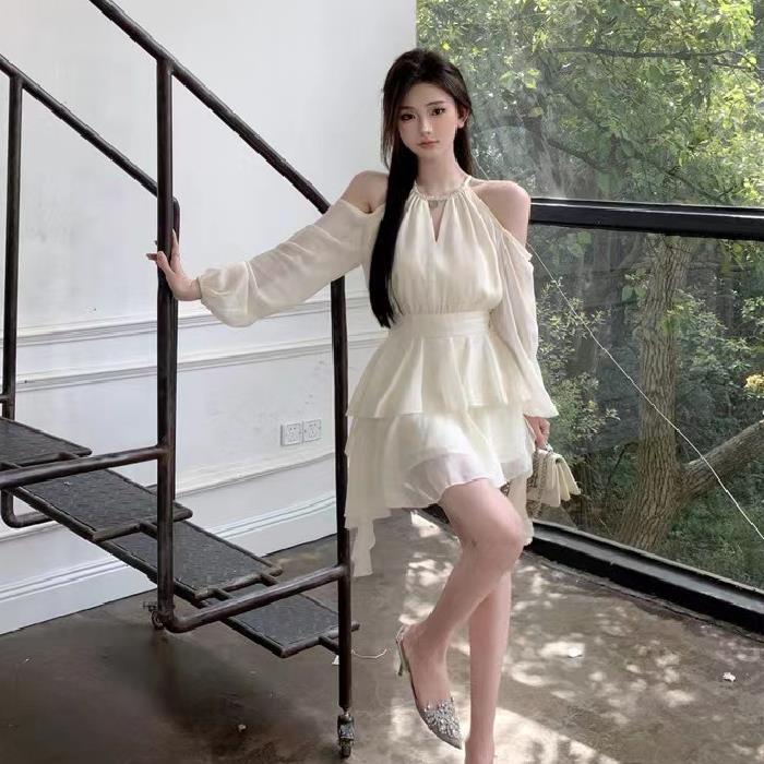 Apricotcolored Longsleeved Dress With A Cinched Waist Slimming Effect And Ethereal Ruffled Hem